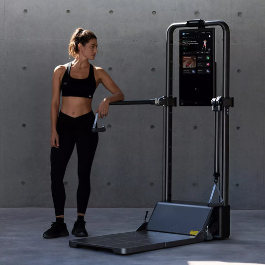 Woman working out with AEKE S1 Pro smart home gym compact all‑in‑one home fitness machine